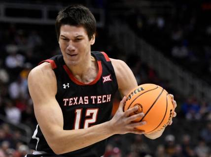 Texas Tech's forward Daniel Batcho (12) rebounds the ball against West Virginia in the first round of the Big 12 basketball tournament, Wednesday, March 8, 2023, at T-Mobile Center in Kansas City.