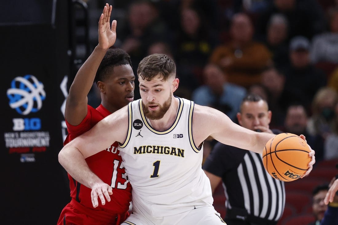 Mar 9, 2023; Chicago, IL, USA; Michigan Wolverines center Hunter Dickinson (1) is defended by Rutgers Scarlet Knights forward Antwone Woolfolk (13) during the first half at United Center. Mandatory Credit: Kamil Krzaczynski-USA TODAY Sports