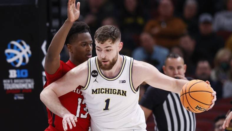 Mar 9, 2023; Chicago, IL, USA; Michigan Wolverines center Hunter Dickinson (1) is defended by Rutgers Scarlet Knights forward Antwone Woolfolk (13) during the first half at United Center. Mandatory Credit: Kamil Krzaczynski-USA TODAY Sports