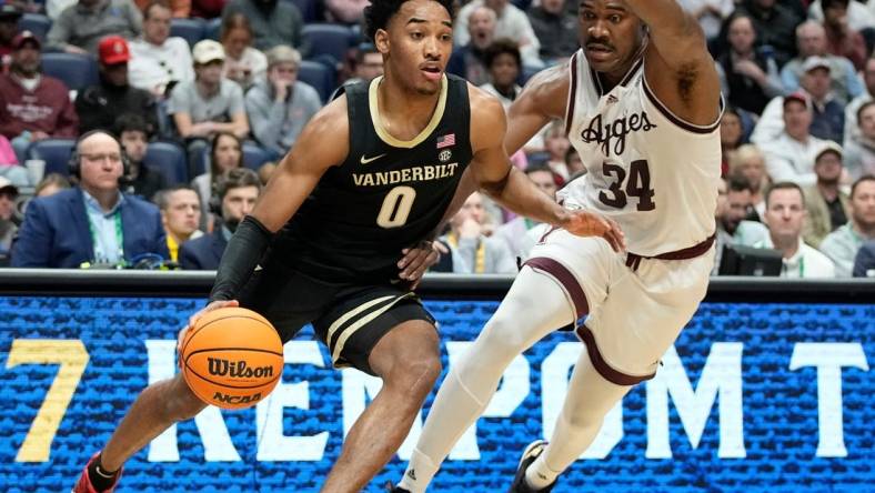 Vanderbilt guard Tyrin Lawrence (0) drives past Texas A&M forward Julius Marble (34) during the first half of a semifinal SEC Men   s Basketball Tournament game at Bridgestone Arena Saturday, March 11, 2023, in Nashville, Tenn.

Sec Basketball Vanderbilt Vs Texas A M