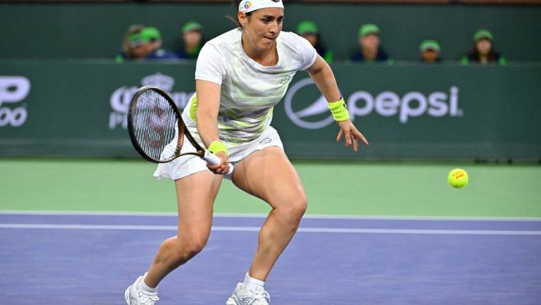 Mar 11, 2023; Indian Wells, CA, USA;  Ons Jabeur (TUN) hits a shot during her second round match against Magdalena Frech (POL) in the BNP Paribas Open at the Indian Wells Tennis Garden. Mandatory Credit: Jayne Kamin-Oncea-USA TODAY Sports