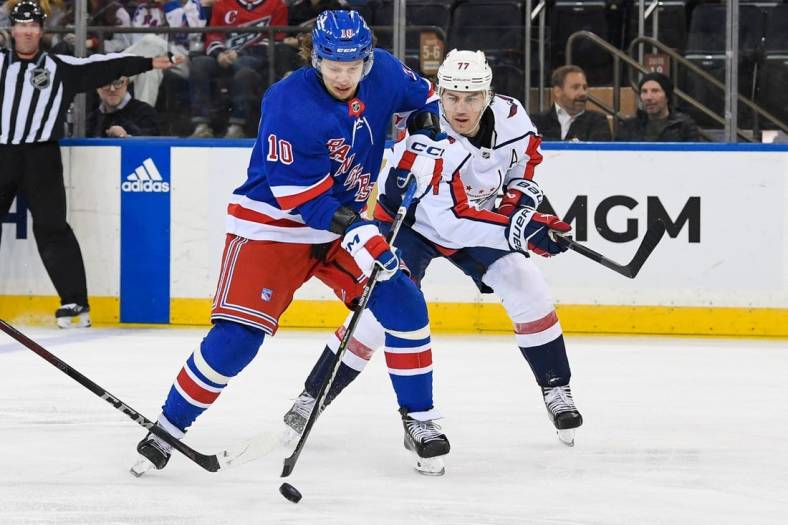 Mar 14, 2023; New York, New York, USA; New York Rangers left wing Artemi Panarin (10) skates with the puck chased by Washington Capitals right wing T.J. Oshie (77)  during the third period at Madison Square Garden. Mandatory Credit: Dennis Schneidler-USA TODAY Sports