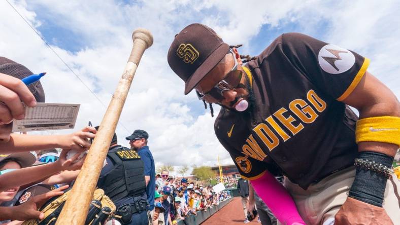 Mar 16, 2023; Salt River Pima-Maricopa, Arizona, USA; San Diego Padres outfielder Fernando Tatis Jr. (23) blows a bubblegum bubble as he signs autographs for fans before the start of the first inning for a spring training game against the Colorado Rockies at Salt River Fields at Talking Stick. Mandatory Credit: Allan Henry-USA TODAY Sports