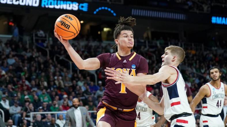 Mar 17, 2023; Albany, NY, USA; Iona Gaels guard Walter Clayton Jr. (1) passes the ball against UConn Huskies guard Joey Calcaterra (3) during the first half at MVP Arena. Mandatory Credit: David Butler II-USA TODAY Sports