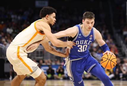 Mar 18, 2023; Orlando, FL, USA; Duke Blue Devils center Kyle Filipowski (30) drives against Tennessee Volunteers forward Olivier Nkamhoua (13) during the first half in the second round of the 2023 NCAA Tournament at Legacy Arena. Mandatory Credit: Matt Pendleton-USA TODAY Sports