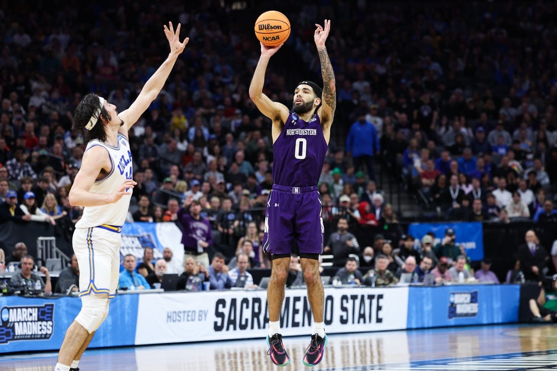 Mar 18, 2023; Sacramento, CA, USA; Northwestern Wildcats guard Boo Buie (0) attempts a three pointer while defended by UCLA Bruins guard Jaime Jaquez Jr. (24) during the second half at Golden 1 Center. Mandatory Credit: Kelley L Cox-USA TODAY Sports