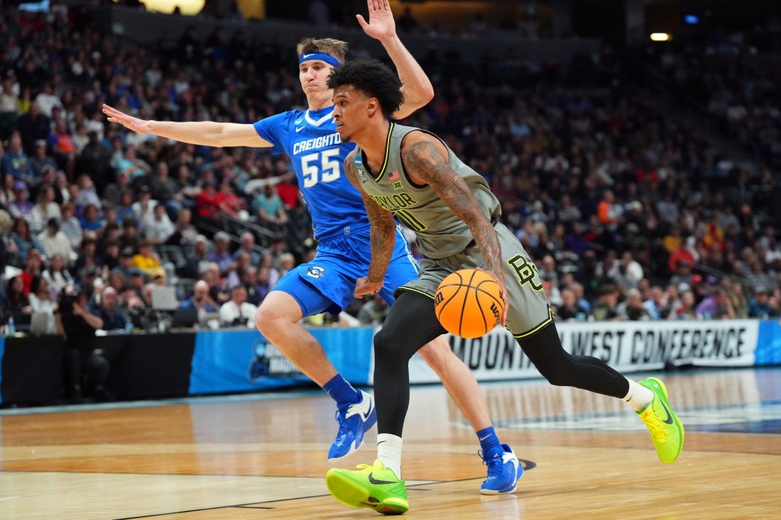 Mar 19, 2023; Denver, CO, USA; Baylor Bears forward Jalen Bridges (11) drives against Creighton Bluejays guard Baylor Scheierman (55) in the first half at Ball Arena. Mandatory Credit: Ron Chenoy-USA TODAY Sports