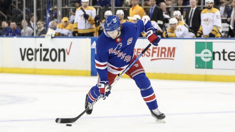 Mar 19, 2023; New York, New York, USA;  New York Rangers defenseman Jacob Trouba (8) attempts a shot on goal in the second period against the Nashville Predators at Madison Square Garden. Mandatory Credit: Wendell Cruz-USA TODAY Sports