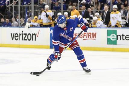 Mar 19, 2023; New York, New York, USA;  New York Rangers defenseman Jacob Trouba (8) attempts a shot on goal in the second period against the Nashville Predators at Madison Square Garden. Mandatory Credit: Wendell Cruz-USA TODAY Sports