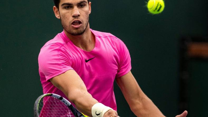 Carlos Alcaraz of Spain hits to Daniil Medvedev of Russia during the men's singles final at the BNP Paribas Open of the Indian Wells Tennis Garden in Indian Wells, Calif., Sunday, March 19, 2023.