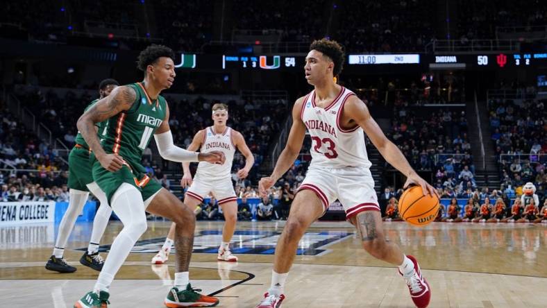 Mar 19, 2023; Albany, NY, USA; Indiana Hoosiers forward Trayce Jackson-Davis (23) dribbles the ball against Miami (Fl) Hurricanes guard Jordan Miller (11) during the second half at MVP Arena. Mandatory Credit: Gregory Fisher-USA TODAY Sports