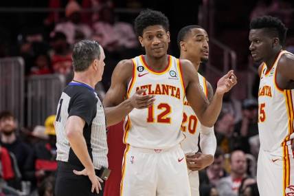 Mar 21, 2023; Atlanta, Georgia, USA; Atlanta Hawks forward De'Andre Hunter (12) discusses a call with the official during the game against the Detroit Pistons during the second half at State Farm Arena. Mandatory Credit: Dale Zanine-USA TODAY Sports