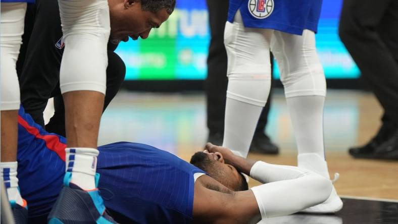 Mar 21, 2023; Los Angeles, California, USA; LA Clippers forward Paul George (13) reacts after suffering an injury against the Oklahoma City Thunder in the second half at Crypto.com Arena. Mandatory Credit: Kirby Lee-USA TODAY Sports