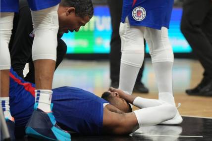 Mar 21, 2023; Los Angeles, California, USA; LA Clippers forward Paul George (13) reacts after suffering an injury against the Oklahoma City Thunder in the second half at Crypto.com Arena. Mandatory Credit: Kirby Lee-USA TODAY Sports