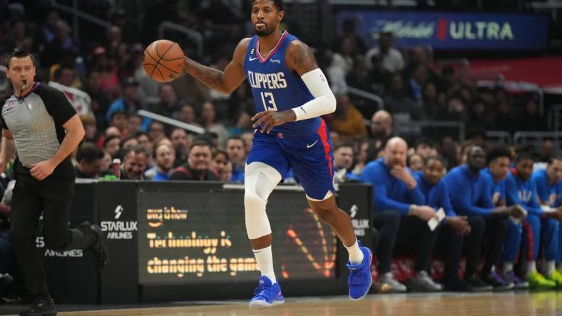 Mar 21, 2023; Los Angeles, California, USA; LA Clippers forward Paul George (13) dribbles the ball against the Oklahoma City Thunder in the first half at Crypto.com Arena. Mandatory Credit: Kirby Lee-USA TODAY Sports