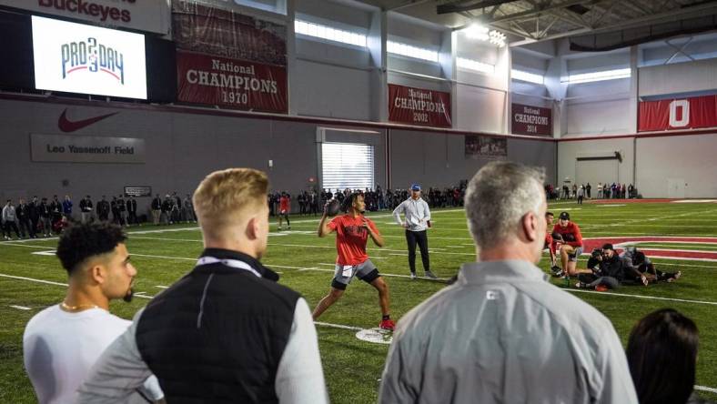 Ohio State Buckeyes quarterback C.J. Stroud throws in front of NFL scouts, including a contingent of Carolina Panthers including head coach Frank Reich, right, and quarterbacks coach Josh McCown, middle, during Ohio State football   s pro day at the Woody Hayes Athletic Center in Columbus on March 22, 2023.

Football Ceb Osufb Pro Day