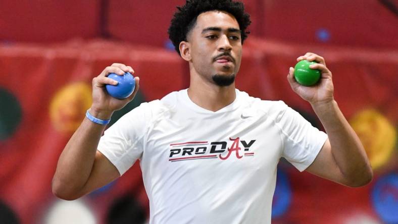 Mar 23, 2023; Tuscaloosa, AL, USA;  Quarterback Bryce Young uses balls to help him loosen up during Pro Day at Hank Crisp Indoor Practice Facility on the campus of the University of Alabama. Mandatory Credit: Gary Cosby Jr.-Tuscaloosa News

Ncaa Football University Of Alabama Pro Day