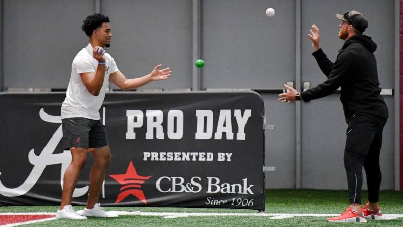 Mar 23, 2023; Tuscaloosa, AL, USA;  Quarterback Bryce Young uses balls to help him loosen up during Pro Day at Hank Crisp Indoor Practice Facility on the campus of the University of Alabama. Mandatory Credit: Gary Cosby Jr.-Tuscaloosa News

Ncaa Football University Of Alabama Pro Day