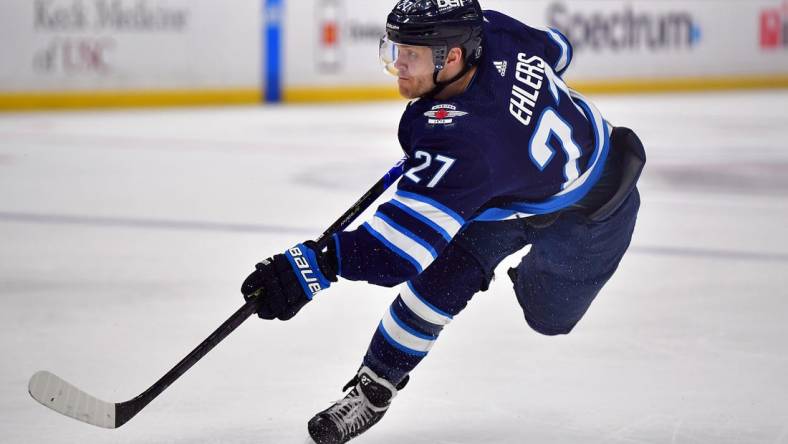 Mar 25, 2023; Los Angeles, California, USA; Winnipeg Jets left wing Nikolaj Ehlers (27) shoots on goal against the Los Angeles Kings during the first period at Crypto.com Arena. Mandatory Credit: Gary A. Vasquez-USA TODAY Sports