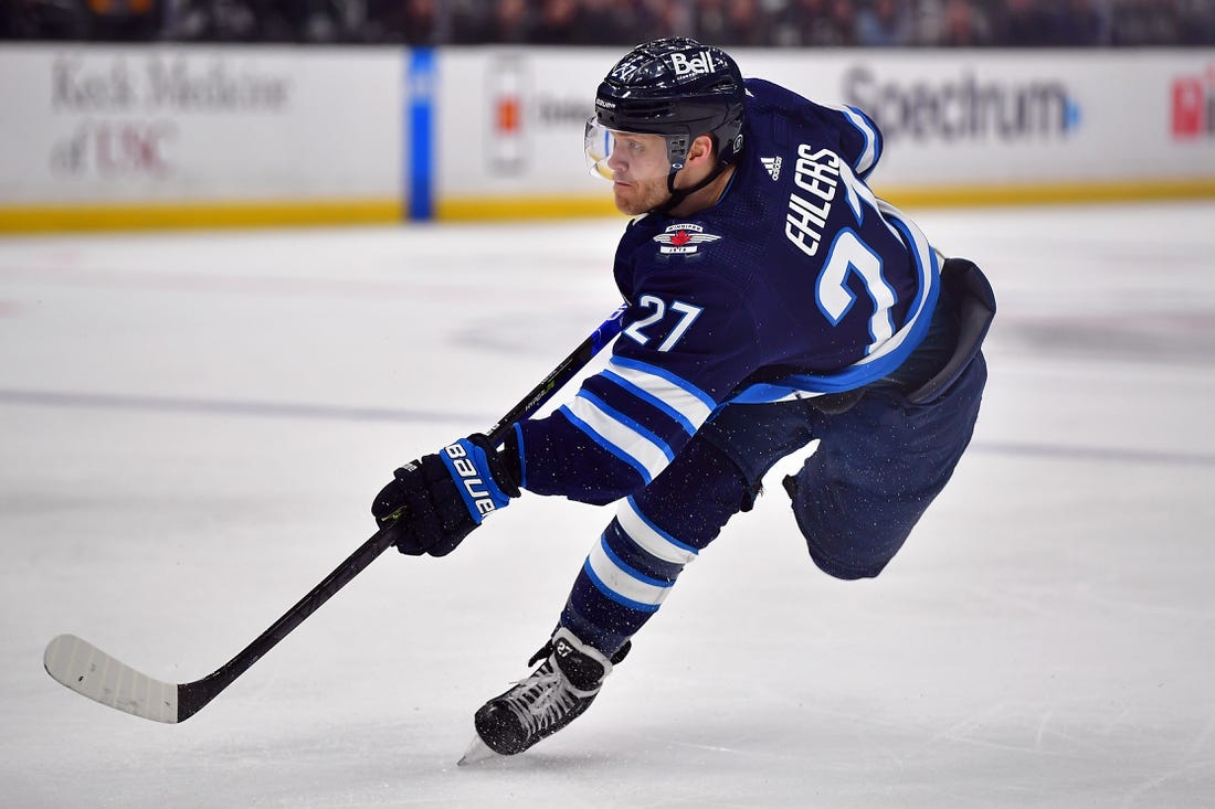 Mar 25, 2023; Los Angeles, California, USA; Winnipeg Jets left wing Nikolaj Ehlers (27) shoots on goal against the Los Angeles Kings during the first period at Crypto.com Arena. Mandatory Credit: Gary A. Vasquez-USA TODAY Sports