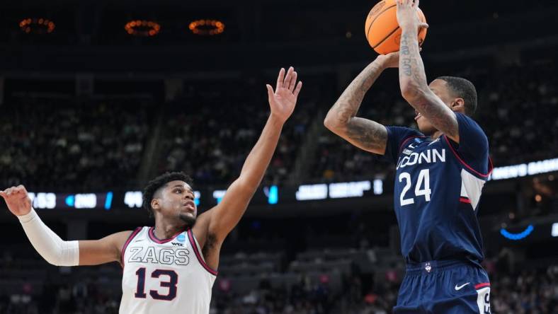 Mar 25, 2023; Las Vegas, NV, USA; Connecticut Huskies guard Jordan Hawkins (24) shoots the ball over Gonzaga Bulldogs guard Malachi Smith (13) during the second half for the NCAA tournament West Regional final at T-Mobile Arena. Mandatory Credit: Joe Camporeale-USA TODAY Sports