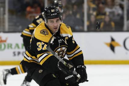 Mar 28, 2023; Boston, Massachusetts, USA; Boston Bruins center Patrice Bergeron (37) eyes a loose puck against the Nashville Predators during the first period at TD Garden. Mandatory Credit: Winslow Townson-USA TODAY Sports