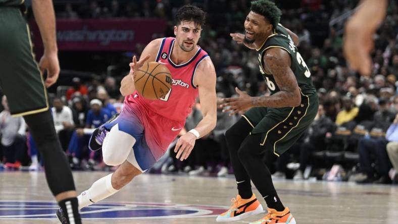 Mar 28, 2023; Washington, District of Columbia, USA; Washington Wizards forward Deni Avdija (9) dribbles past Boston Celtics guard Marcus Smart (36) during the second half at Capital One Arena. Mandatory Credit: Brad Mills-USA TODAY Sports