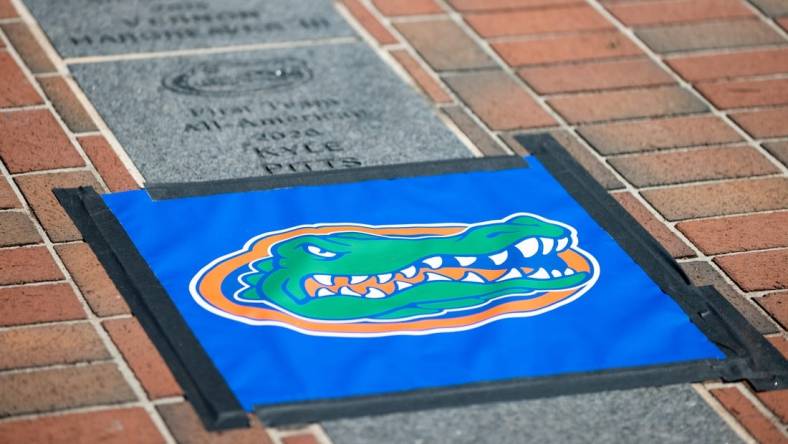 A Florida Gators logo protecting the spot where Florida Gators offensive lineman O'Cyrus Torrence (54) All-American brick will be installed outside Ben Hill Griffin Stadium in Gainesville, FL on Wednesday, March 29, 2023. [Matt Pendleton/Gainesville Sun]

Ncaa Football O Cyrus Torrence All American Brick Dedication