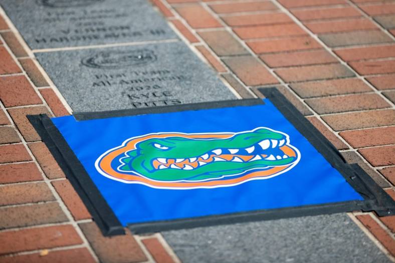 A Florida Gators logo protecting the spot where Florida Gators offensive lineman O'Cyrus Torrence (54) All-American brick will be installed outside Ben Hill Griffin Stadium in Gainesville, FL on Wednesday, March 29, 2023. [Matt Pendleton/Gainesville Sun]

Ncaa Football O Cyrus Torrence All American Brick Dedication