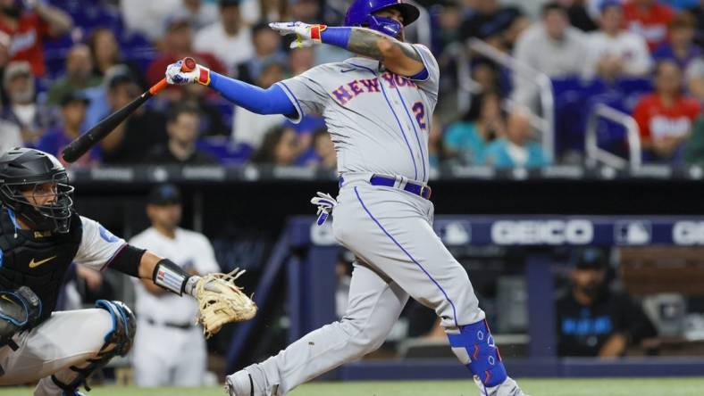 Mar 30, 2023; Miami, Florida, USA; New York Mets catcher Omar Narvaez (2) hits a single during the third inning against the Miami Marlins at loanDepot Park. Mandatory Credit: Sam Navarro-USA TODAY Sports