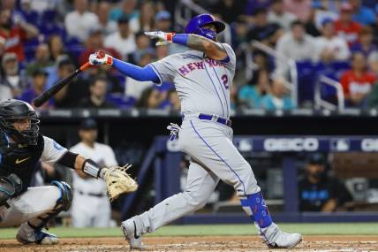 Mar 30, 2023; Miami, Florida, USA; New York Mets catcher Omar Narvaez (2) hits a single during the third inning against the Miami Marlins at loanDepot Park. Mandatory Credit: Sam Navarro-USA TODAY Sports