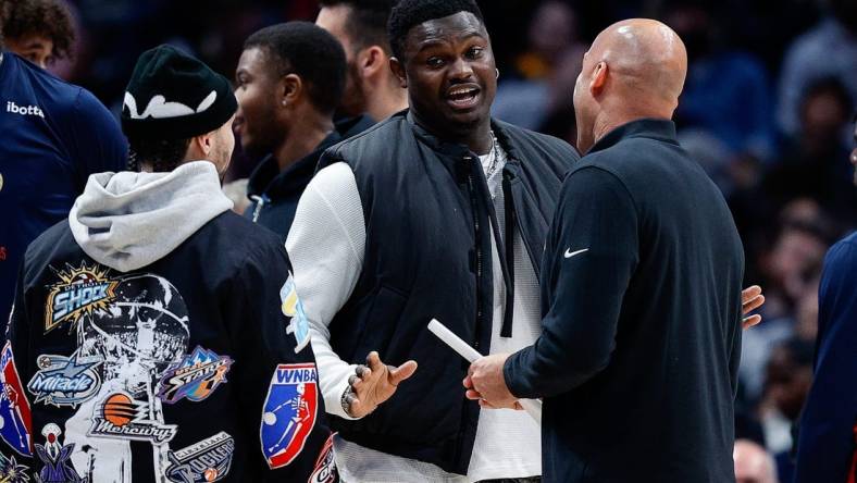 Mar 30, 2023; Denver, Colorado, USA; New Orleans Pelicans forward Zion Williamson (C) talks with guard Jose Alvarado (L) and assistant coach Fred Vinson (R) in the second quarter against the Denver Nuggets at Ball Arena. Mandatory Credit: Isaiah J. Downing-USA TODAY Sports