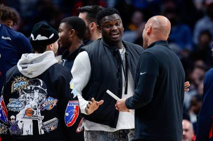 Mar 30, 2023; Denver, Colorado, USA; New Orleans Pelicans forward Zion Williamson (C) talks with guard Jose Alvarado (L) and assistant coach Fred Vinson (R) in the second quarter against the Denver Nuggets at Ball Arena. Mandatory Credit: Isaiah J. Downing-USA TODAY Sports