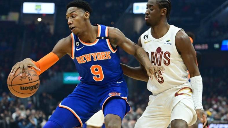 Mar 31, 2023; Cleveland, Ohio, USA; Cleveland Cavaliers guard Caris LeVert (3) defends against New York Knicks guard RJ Barrett (9) during the first half at Rocket Mortgage FieldHouse. Mandatory Credit: Ken Blaze-USA TODAY Sports