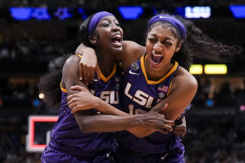 Mar 31, 2023; Dallas, TX, USA; LSU Lady Tigers guard Flau'jae Johnson, left, celebrates with forward Angel Reese after defeating the Virginia Tech Hokies in semifinals of the women's Final Four of the 2023 NCAA Tournament at American Airlines Center. Mandatory Credit: Kirby Lee-USA TODAY Sports