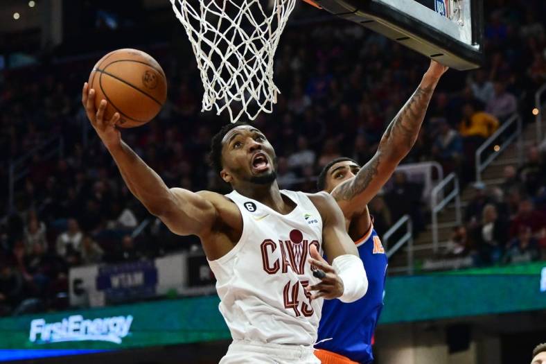Mar 31, 2023; Cleveland, Ohio, USA; Cleveland Cavaliers guard Donovan Mitchell (45) drives to the basket against New York Knicks forward Obi Toppin (1) during the second half at Rocket Mortgage FieldHouse. Mandatory Credit: Ken Blaze-USA TODAY Sports