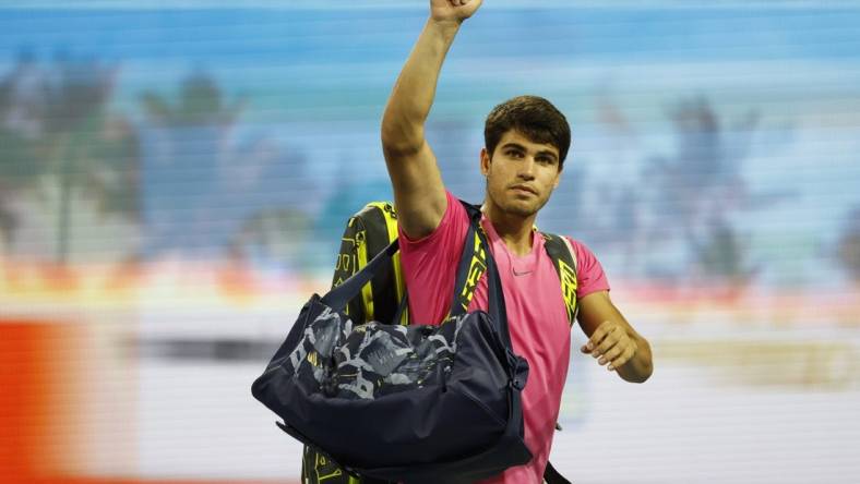 Mar 31, 2023; Miami, Florida, US; Carlos Alcaraz (ESP) waves to the crowd while leaving the court after his match against Jannik Sinner (ITA) (not pictured) in a men's singles semifinal on day twelve on the Miami Open at Hard Rock Stadium. Mandatory Credit: Geoff Burke-USA TODAY Sports