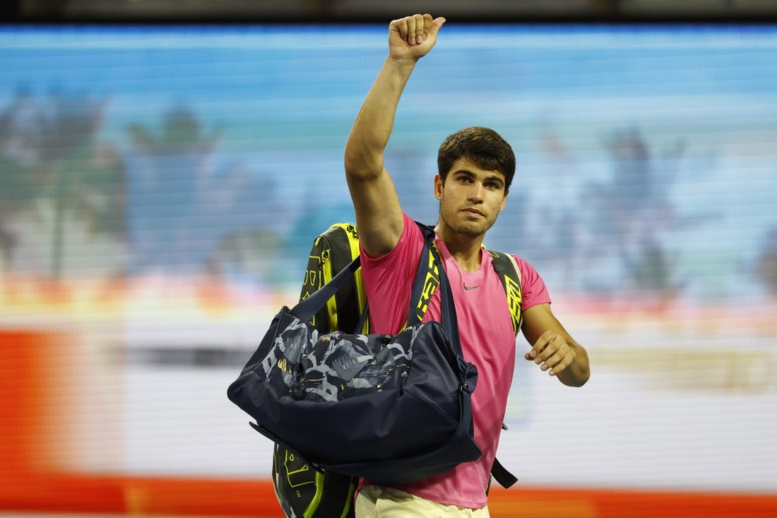 Mar 31, 2023; Miami, Florida, US; Carlos Alcaraz (ESP) waves to the crowd while leaving the court after his match against Jannik Sinner (ITA) (not pictured) in a men's singles semifinal on day twelve on the Miami Open at Hard Rock Stadium. Mandatory Credit: Geoff Burke-USA TODAY Sports