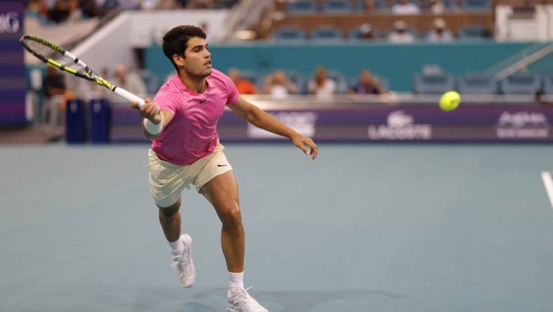 Mar 31, 2023; Miami, Florida, US; Carlos Alcaraz (ESP) reaches for a forehand against Jannik Sinner (ITA) (not pictured) in a men's singles semifinal on day twelve on the Miami Open at Hard Rock Stadium. Mandatory Credit: Geoff Burke-USA TODAY Sports