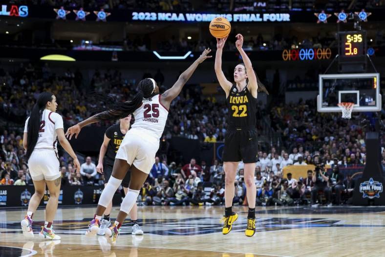 Mar 31, 2023; Dallas, TX, USA; Iowa Hawkeyes guard Caitlin Clark (22) attempts a three-point basket against South Carolina Gamecocks guard Raven Johnson (25) in the second half in semifinals of the women's Final Four of the 2023 NCAA Tournament at American Airlines Center. Mandatory Credit: Kevin Jairaj-USA TODAY Sports