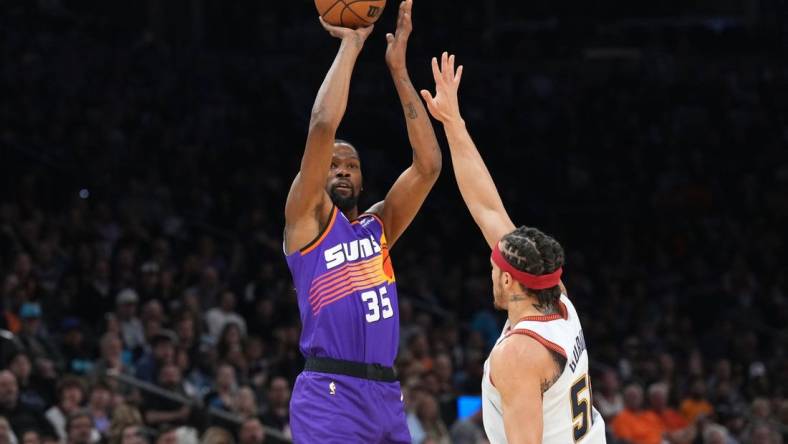 Mar 31, 2023; Phoenix, Arizona, USA; Phoenix Suns forward Kevin Durant (35) shoots over Denver Nuggets forward Aaron Gordon (50) during the first half at Footprint Center. Mandatory Credit: Joe Camporeale-USA TODAY Sports