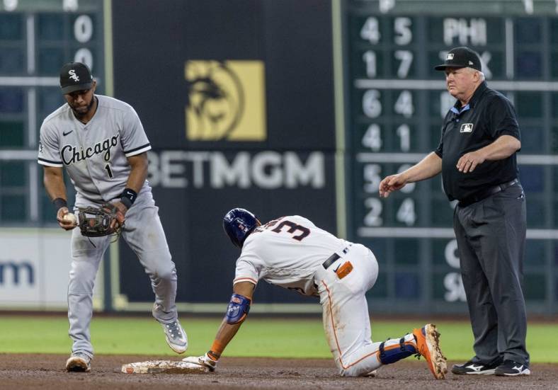 Apr 1, 2023; Houston, Texas, USA; Houston Astros shortstop Jeremy Pena (3) is safe with a RBI double against Chicago White Sox second baseman Elvis Andrus (1) in the fourth inning at Minute Maid Park. Mandatory Credit: Thomas Shea-USA TODAY Sports