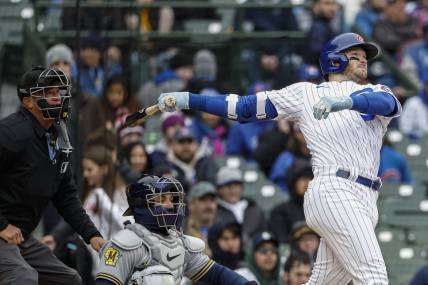 Apr 1, 2023; Chicago, Illinois, USA; Chicago Cubs left fielder Ian Happ (8) hits a solo home run against the Milwaukee Brewers during the sixth inning at Wrigley Field. Mandatory Credit: Kamil Krzaczynski-USA TODAY Sports
