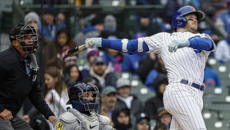 Apr 1, 2023; Chicago, Illinois, USA; Chicago Cubs left fielder Ian Happ (8) hits a solo home run against the Milwaukee Brewers during the sixth inning at Wrigley Field. Mandatory Credit: Kamil Krzaczynski-USA TODAY Sports