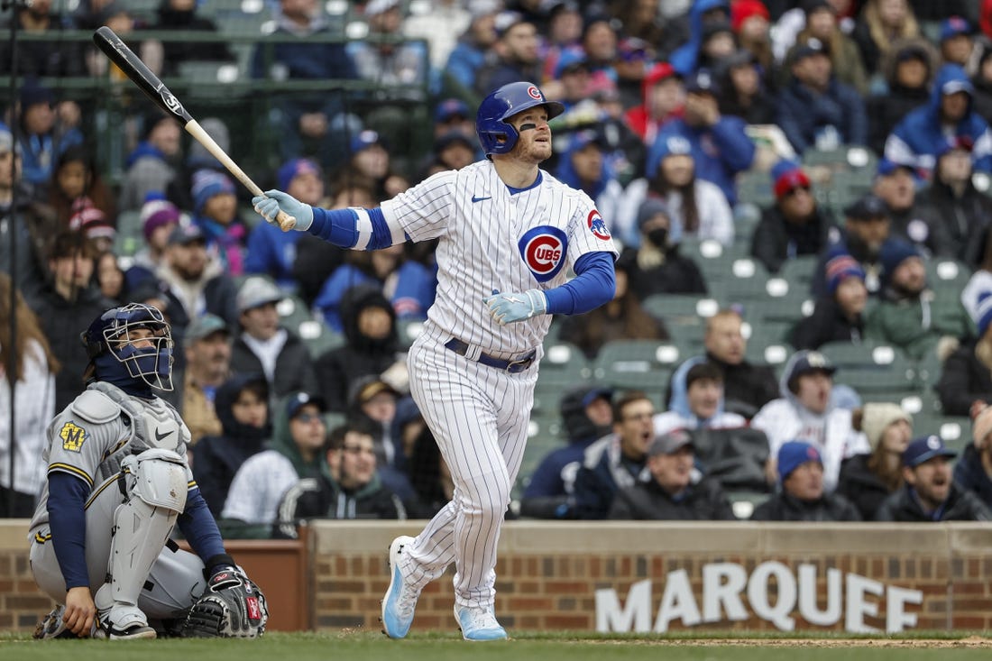 Apr 1, 2023; Chicago, Illinois, USA; Chicago Cubs left fielder Ian Happ (8) hits a solo home run against the Milwaukee Brewers during the sixth inning at Wrigley Field. Mandatory Credit: Kamil Krzaczynski-USA TODAY Sports