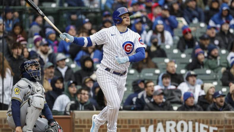 Apr 1, 2023; Chicago, Illinois, USA; Chicago Cubs left fielder Ian Happ (8) hits a solo home run against the Milwaukee Brewers during the sixth inning at Wrigley Field. Mandatory Credit: Kamil Krzaczynski-USA TODAY Sports