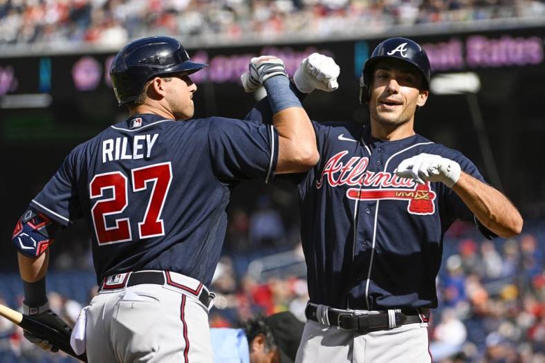 Apr 1, 2023; Washington, District of Columbia, USA; Atlanta Braves first baseman Matt Olson (28) celebrates with third baseman Austin Riley (27) after hitting a solo home run against the Washington Nationals during the first inning at Nationals Park. Mandatory Credit: Brad Mills-USA TODAY Sports