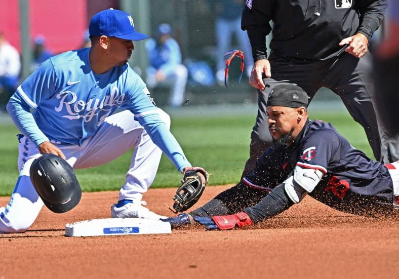 Apr 1, 2023; Kansas City, Missouri, USA;  Minnesota Twins designated hitter Byron Buxton (25) dives into second base with a double during the first inning against Kansas City Royals second baseman Nicky Lopez (8) at Kauffman Stadium. Mandatory Credit: Peter Aiken-USA TODAY Sports