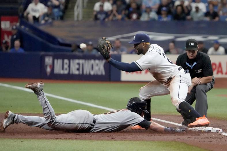 Apr 1, 2023; St. Petersburg, Florida, USA; Detroit Tigers third baseman Nick Maton (9) dives back to first as Tampa Bay Rays first baseman Yandy Diaz (2) tries unsuccessfully to make the tag during the third inning at Tropicana Field. Mandatory Credit: Dave Nelson-USA TODAY Sports