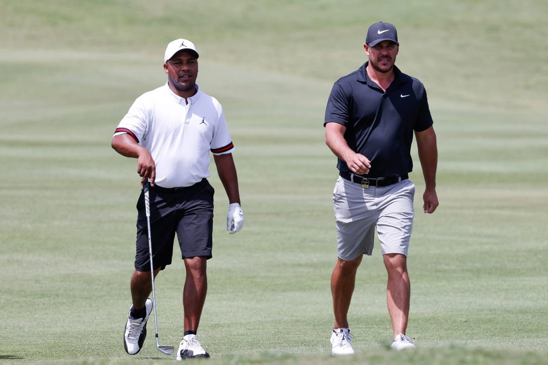 Apr 1, 2023; Orlando, Florida, USA; Harold Varner III of the RangeGoats (left) and Brooks Koepka of the Smash golf club walk onto the fourth green during the second round of a LIV Golf event at Orange County National. Mandatory Credit: Reinhold Matay-USA TODAY Sports